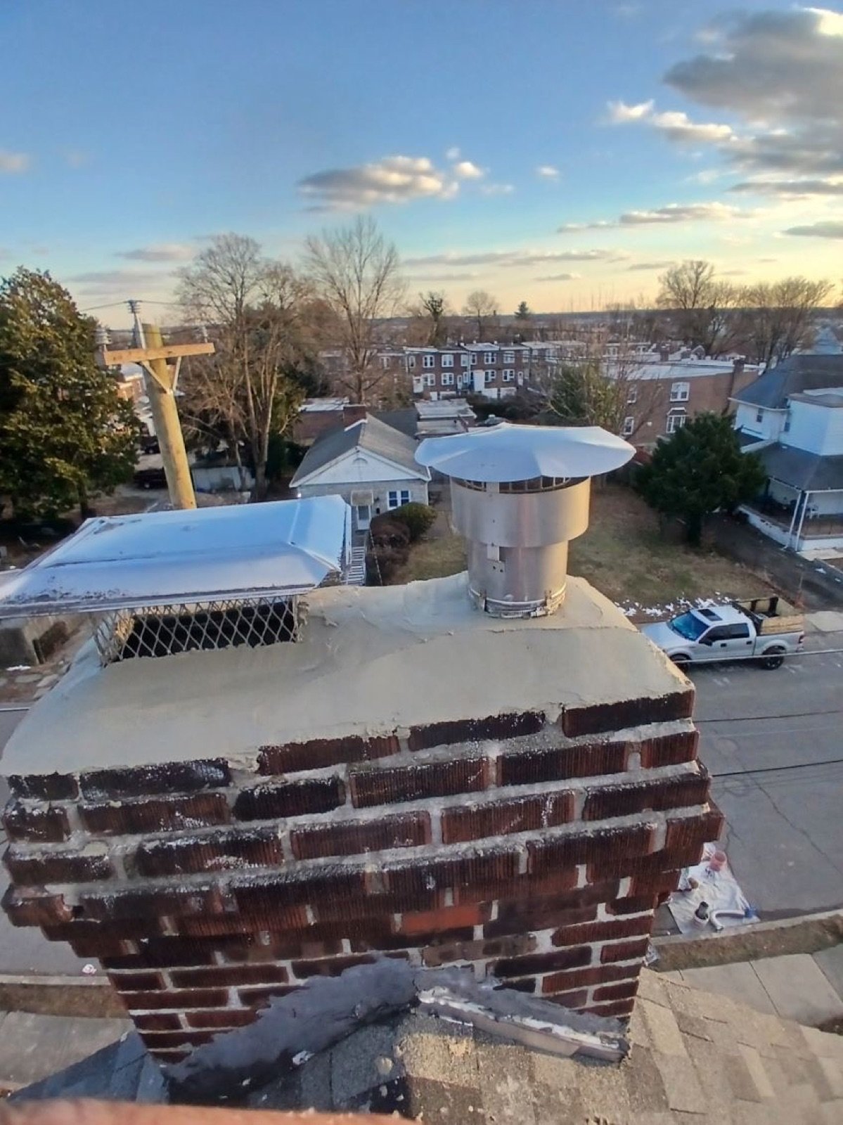 Brick chimney with new crown and dual stainless steel caps